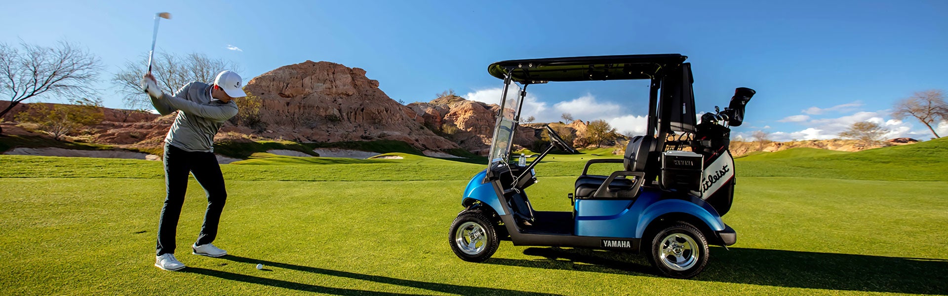 Golfer next to Yamaha cart